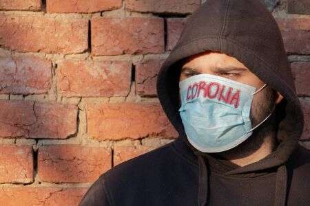 141376454-man-in-hood-with-mask-to-protect-him-from-coronavirus-corona-ANA.jpg